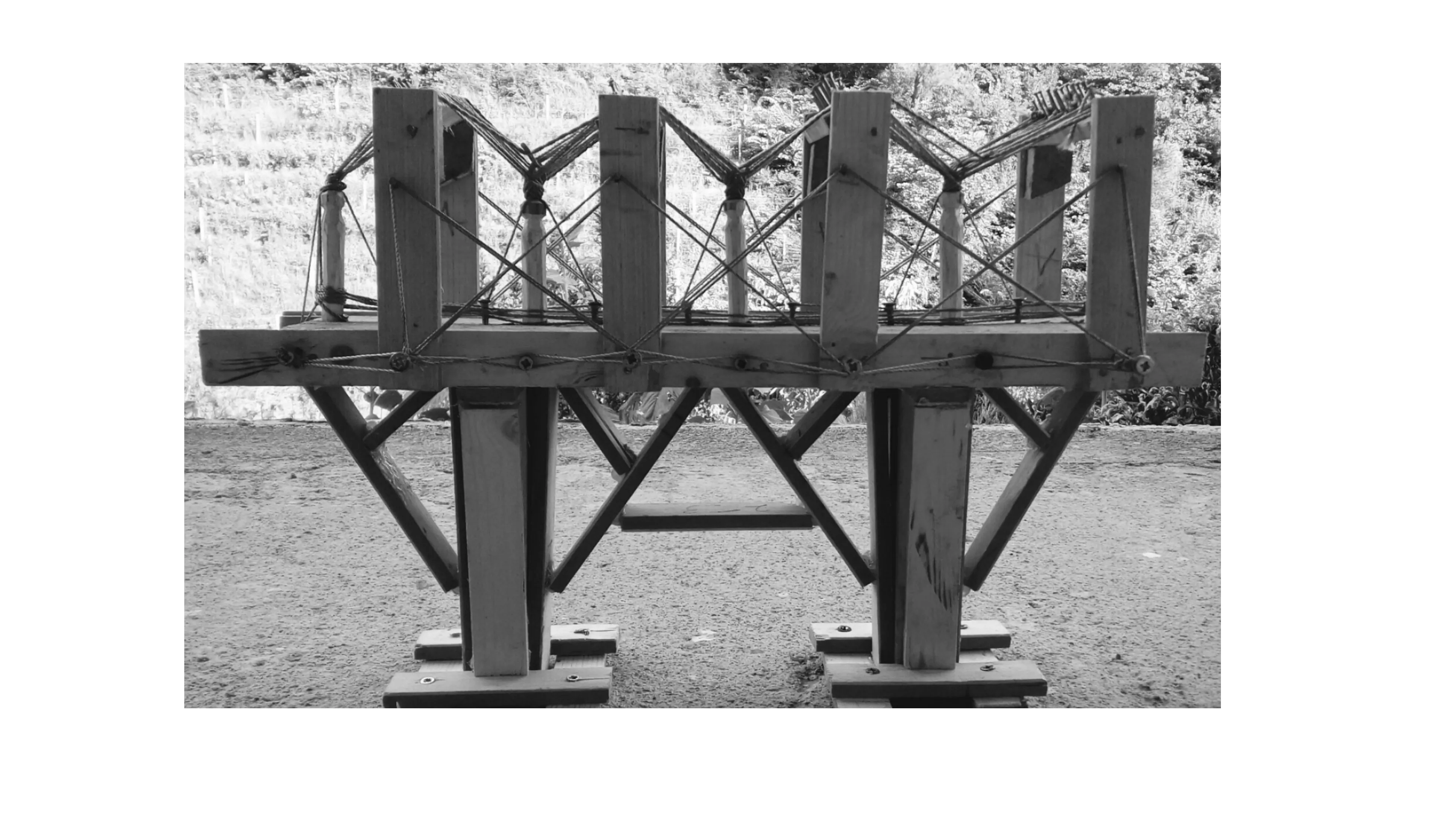 Handcrafted wooden bridge, meticulously assembled from small pieces.