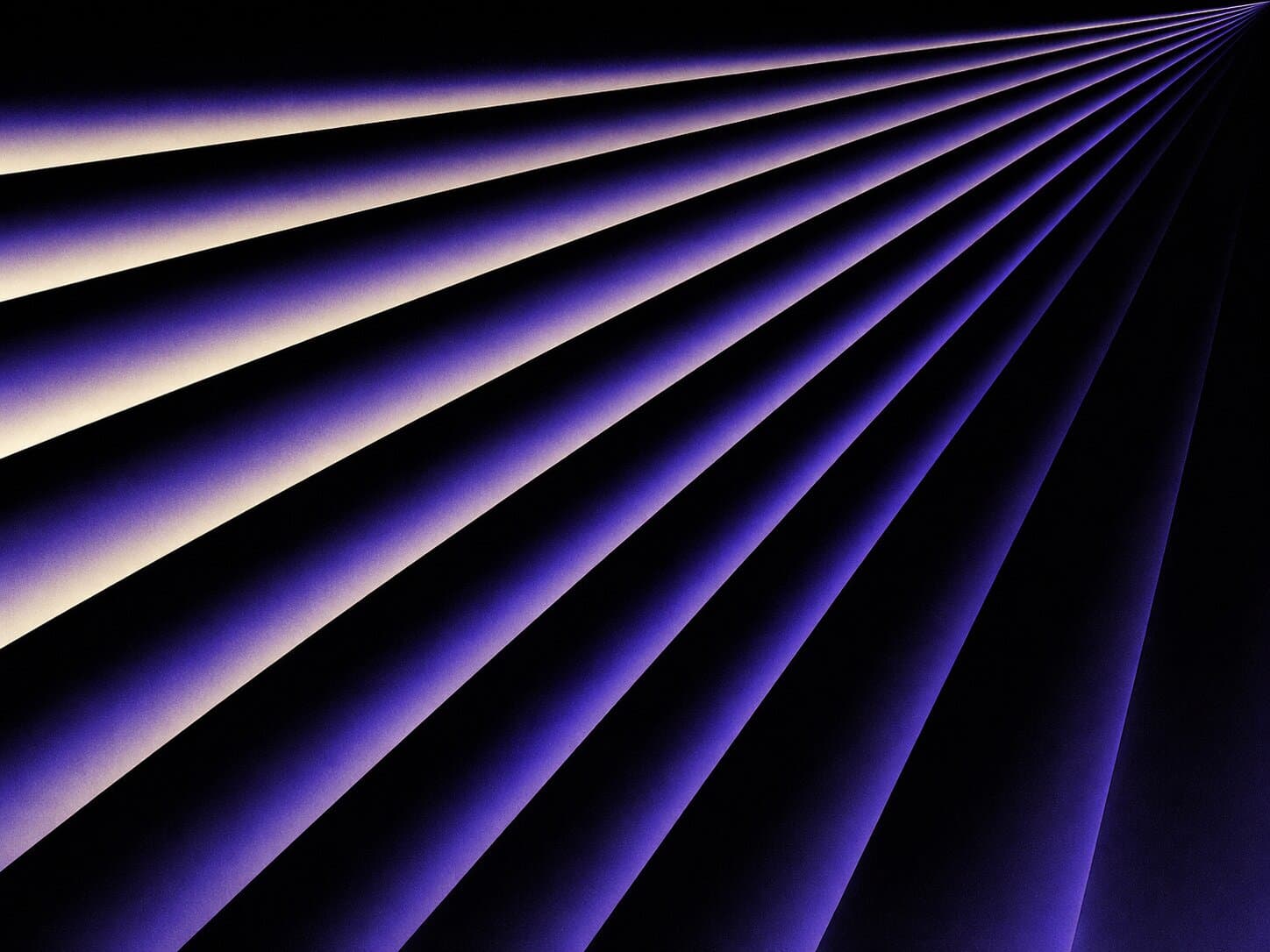 Converging purple light beams on a dark background, used on the about page
