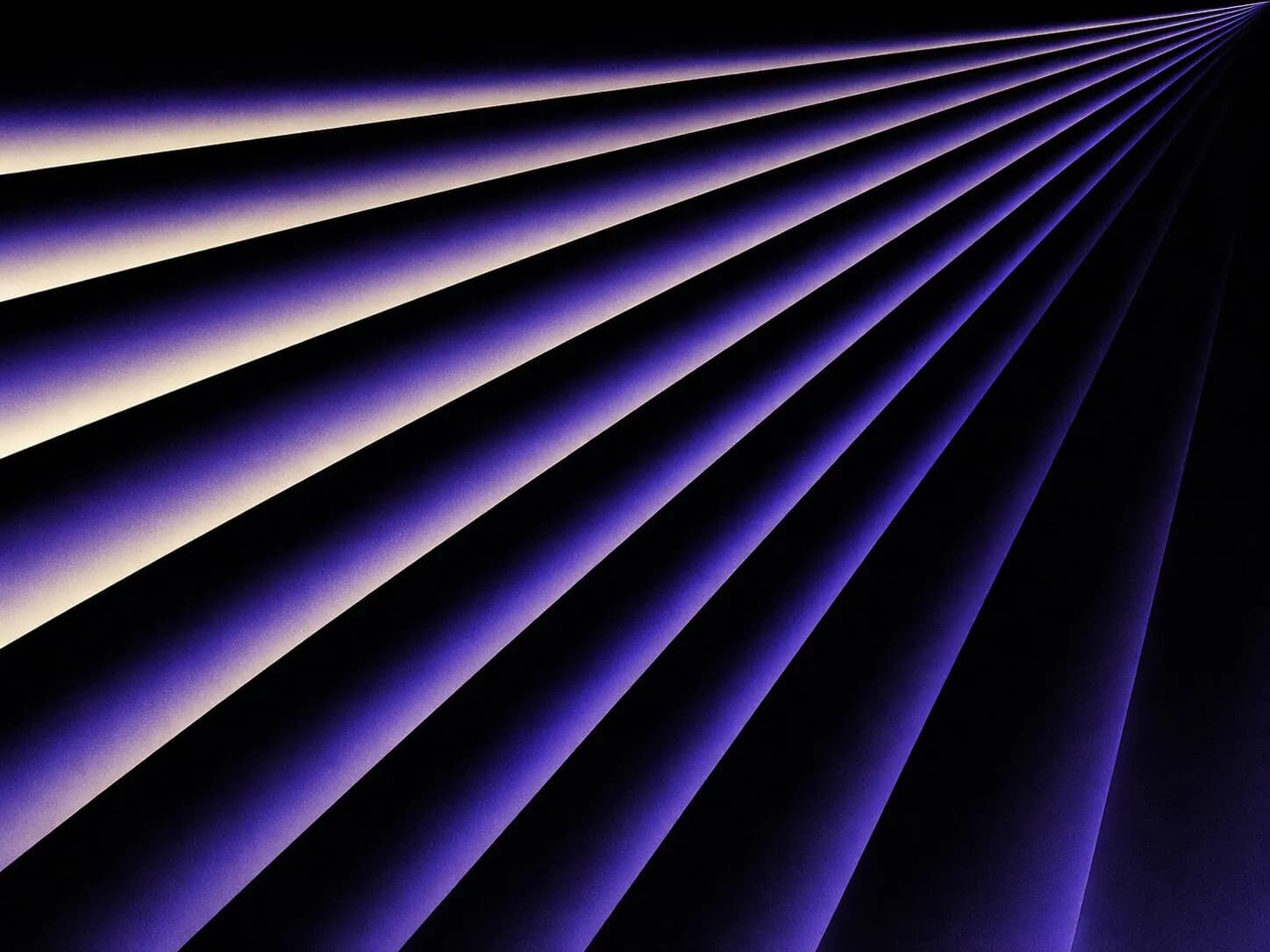 Converging purple light beams on a dark background, used on the about page